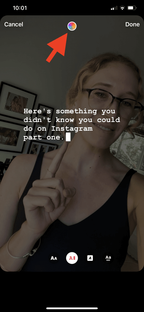 Screenshot of an Instagram Story using the captions feature with a red arrow pointing to a color wheel on the top of the screen showing users how to change the color of their captions text.